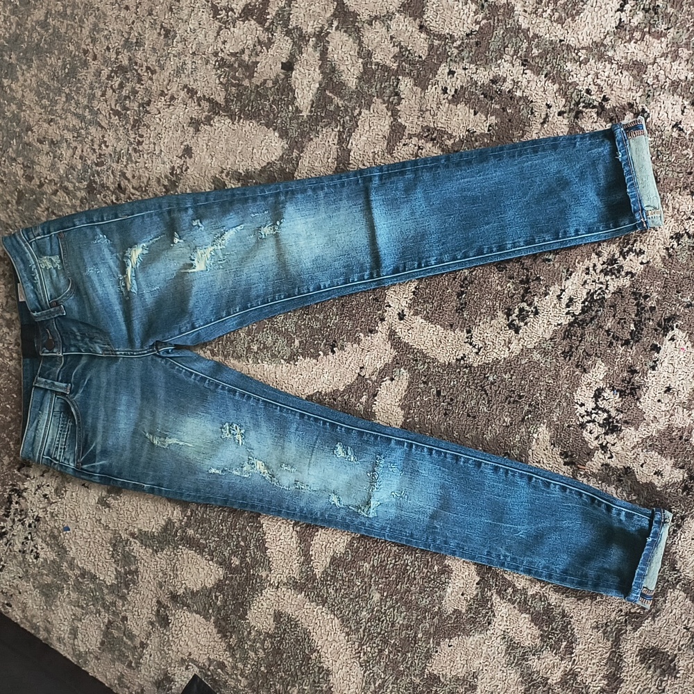Buckle mid-rise skinny jeans.